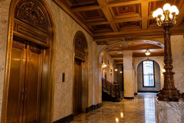 The marble lobby and brass elevator doors of a grand Chicago municipal building