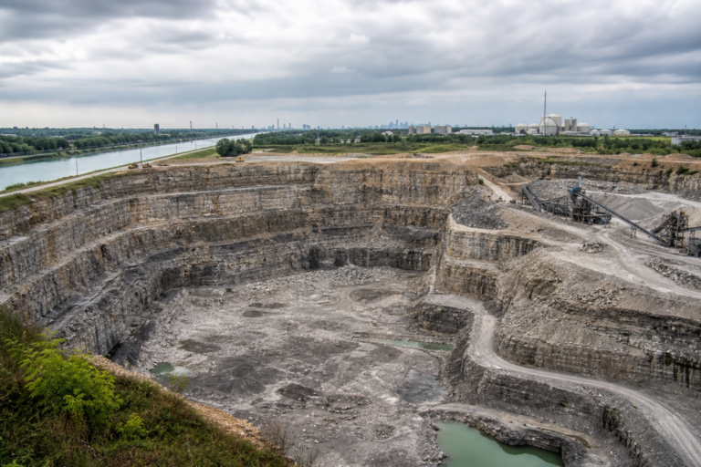 Terraced limestone walls of a reservoir quarry under excavation beside a canal near Chicago