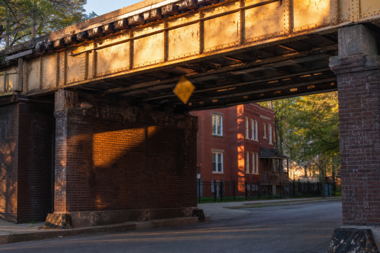 Low rail viaduct over a Chicago side street in warm light