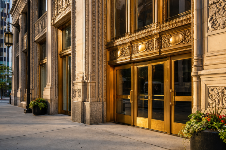 Brass doors of a classic Chicago office tower in morning light
