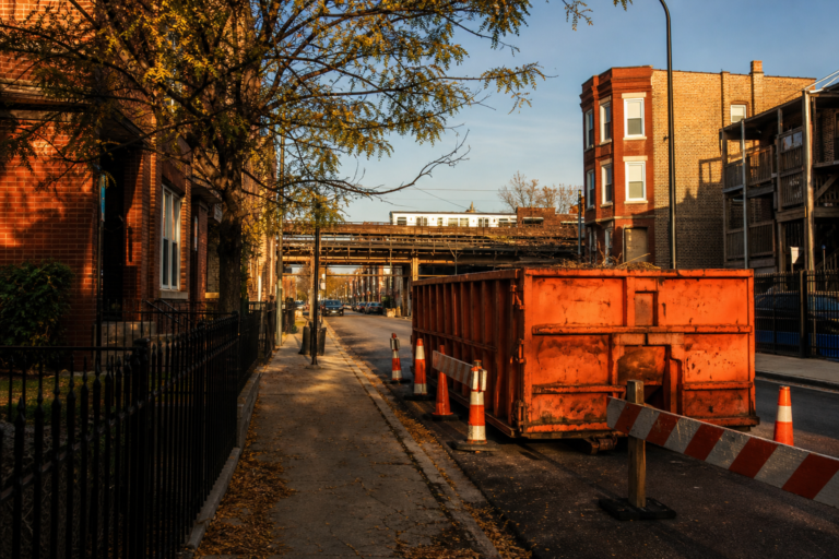 Chicago side street with a dumpster and construction barricades
