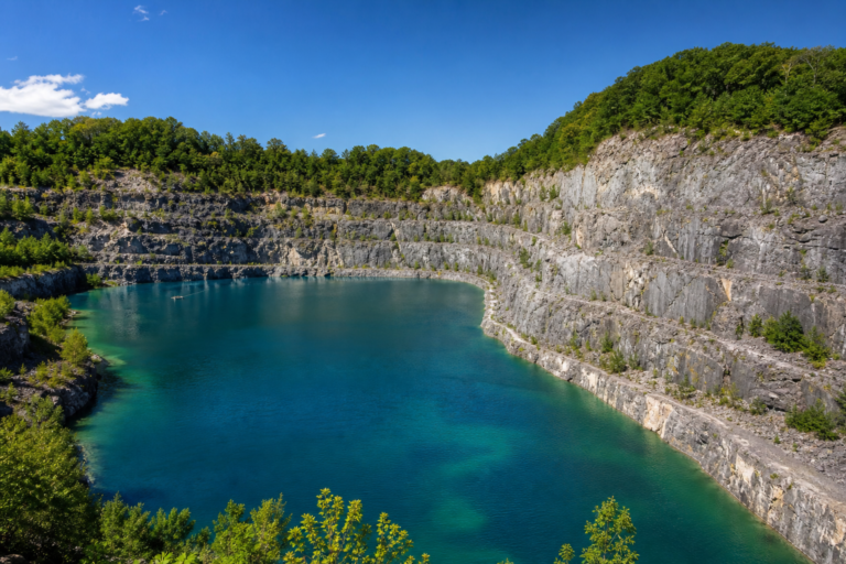 A quarry reservoir with turquoise water on a bright sunny day