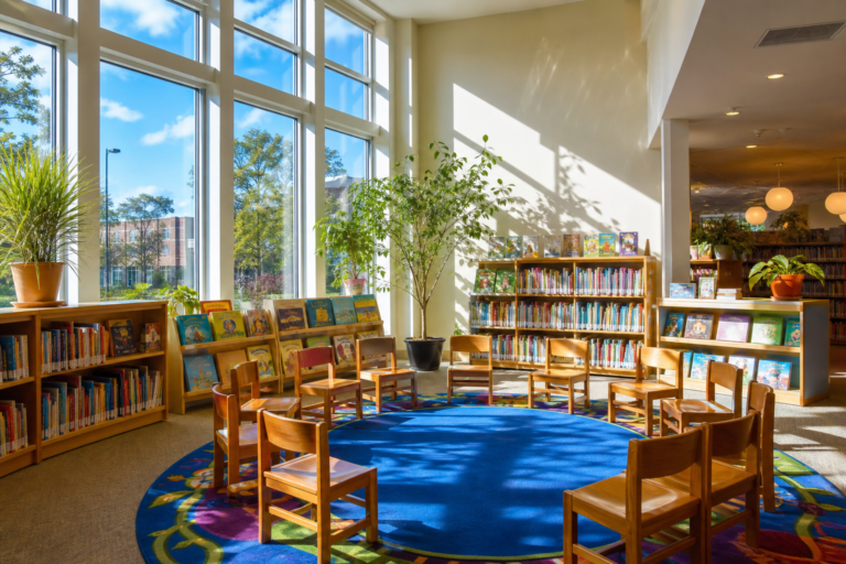 A bright children's reading room with small chairs in a circle