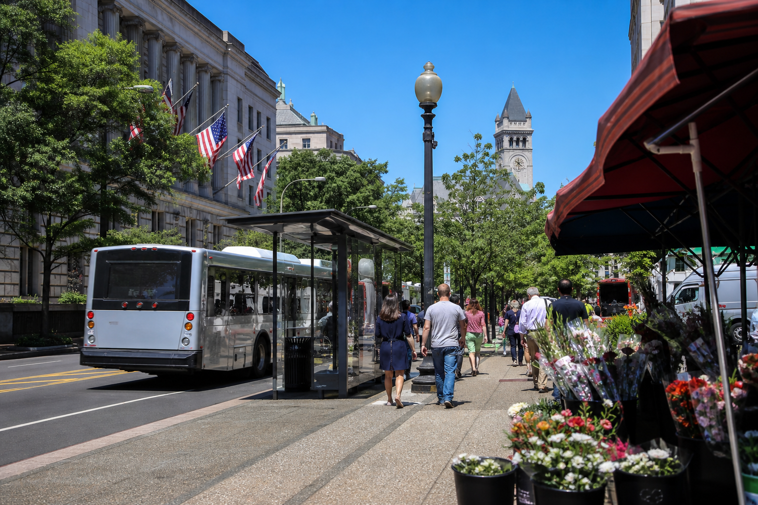 A city bus at a stop on a sunny downtown street
